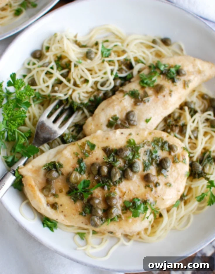 Zesty Lemon Caper Chicken 3 Chicken Piccata garnished with fresh parsley, close up.