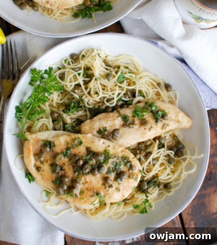 Zesty Lemon Caper Chicken 4 Overhead shot of Easy Chicken Piccata garnished with fresh parsley, ready to serve.