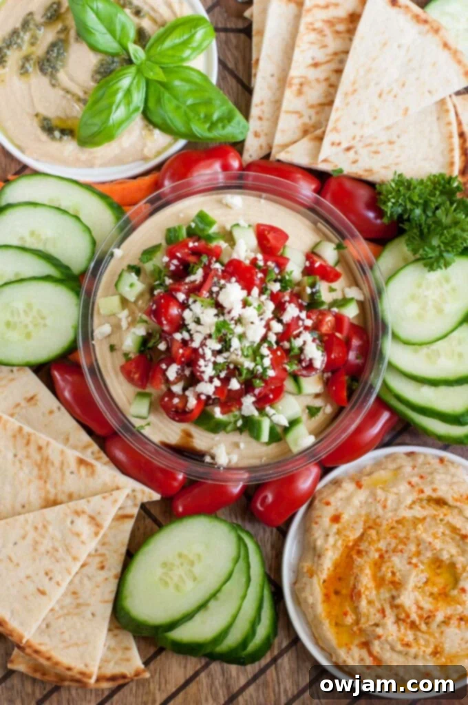 Snag a tub of your favorite hummus and whip up this Mediterranean Bruschetta Hummus topped with tomato, cucumber and feta.Hummus snack platter for a tasty pre-dinner nosh that's sure to satisfy!