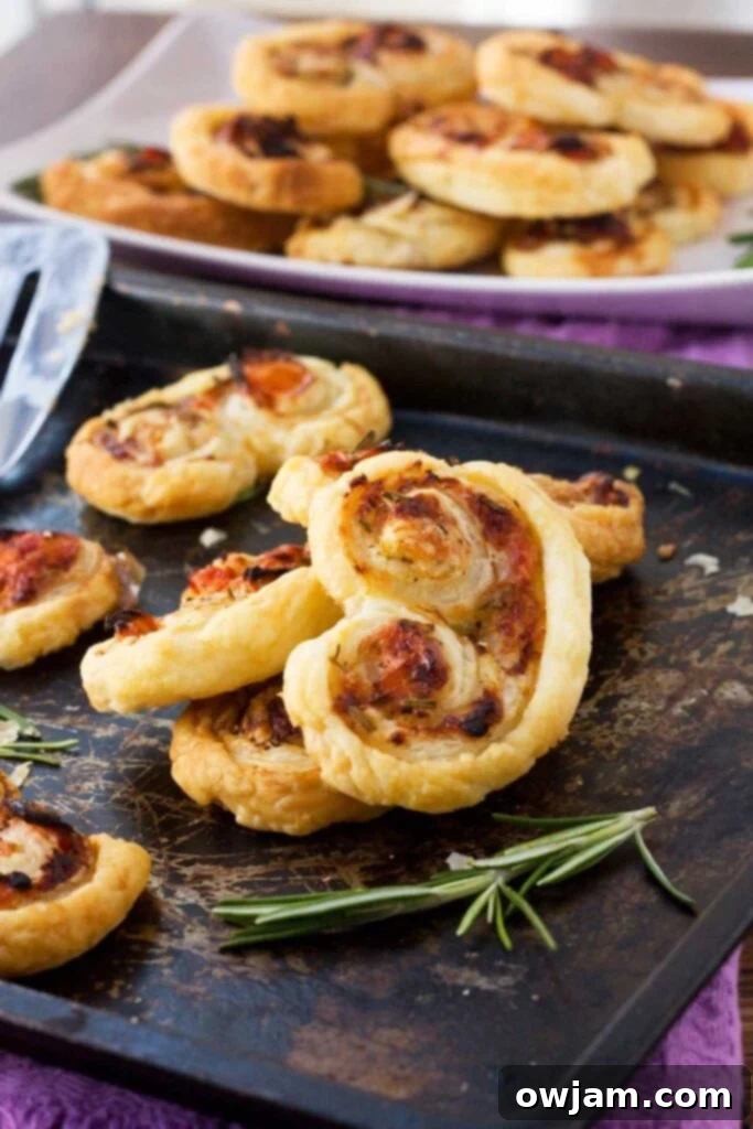 Easy puff pastry ‘palmiers’ stuffed with tasty sun-dried tomatoes, parmesan & fresh rosemary.