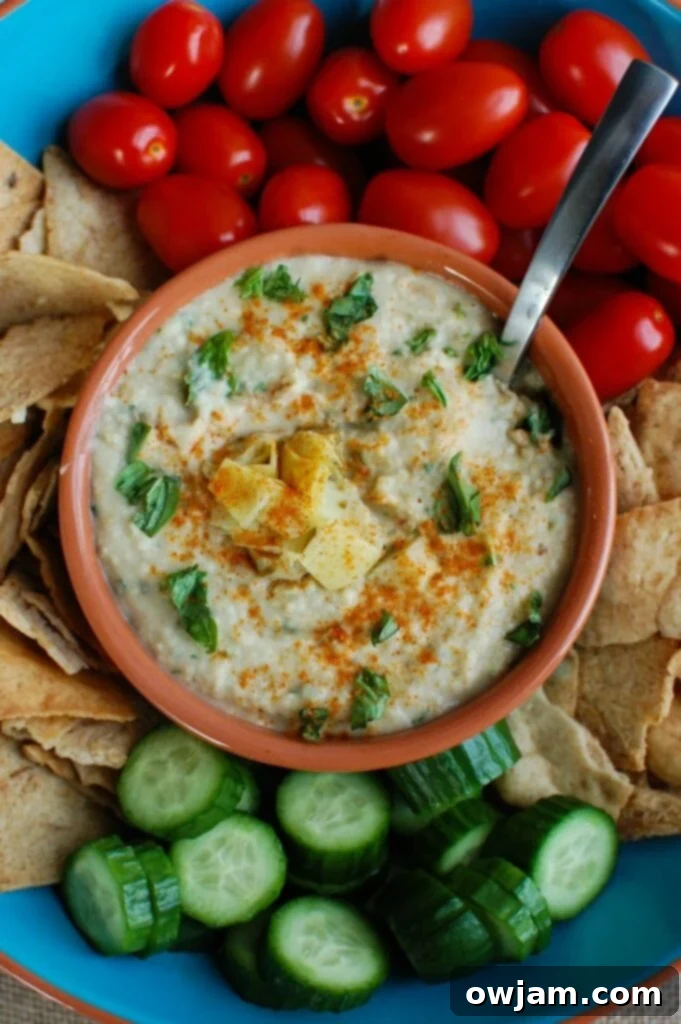 White Bean Artichoke Dip is a healthy appetizer, snack or spread for sandwiches. White beans, artichokes, lemon juice, olive oil, cayenne pepper, basil and garlic are blended and topped with fresh basil and parsley to create a healthy, flavorful dip.