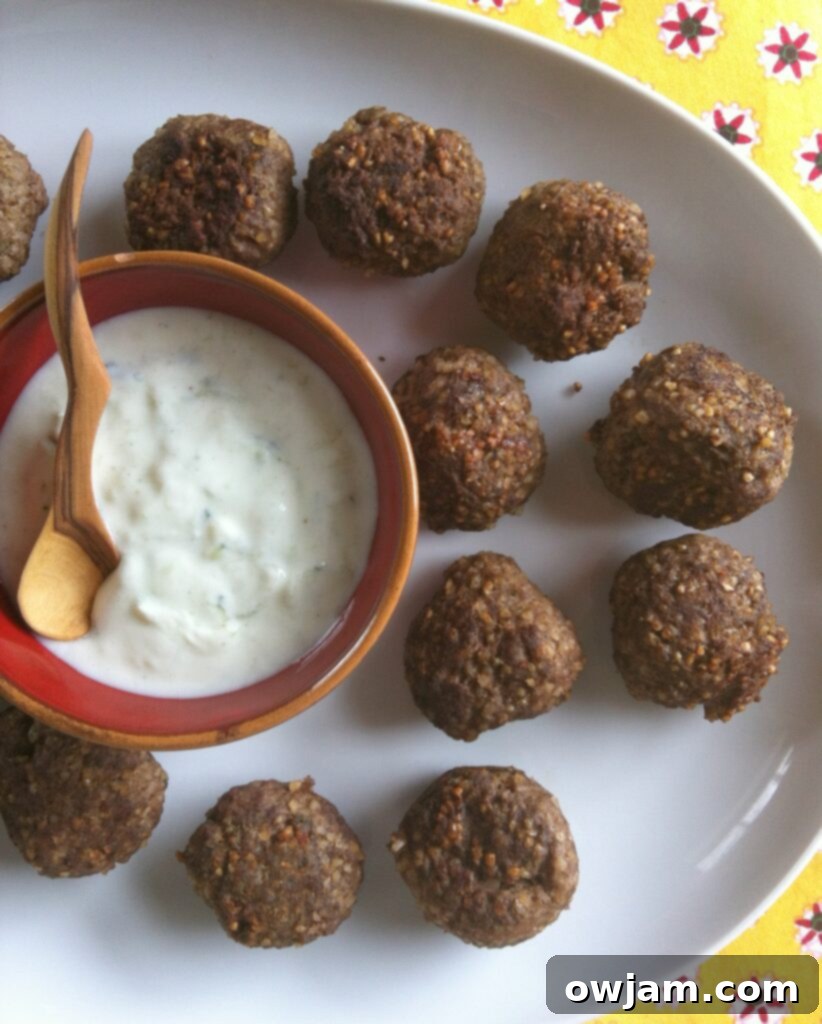 Kibbeh Meatballs With Spiced Yogurt Sauce is a delicious Lebanese appetizer or main dish recipe that’s traditionally made with ground lamb. These easy meatballs are made with beef, with Lebanese spices.