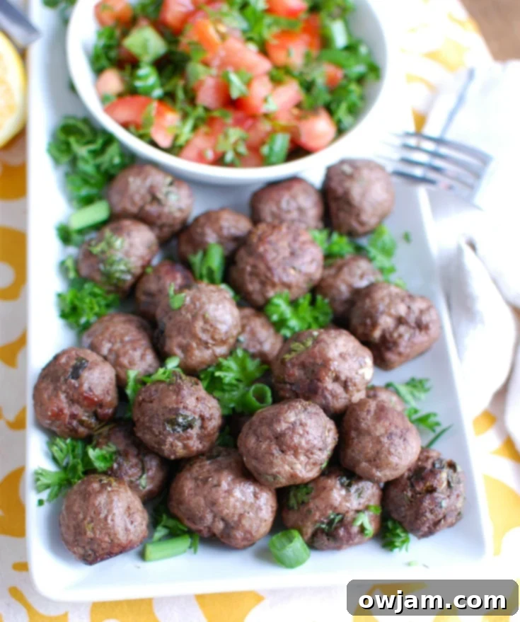 Aromatic Kafta Beef Meatballs 4 Platter of freshly baked Beef Kafta Meatballs garnished with fresh herbs