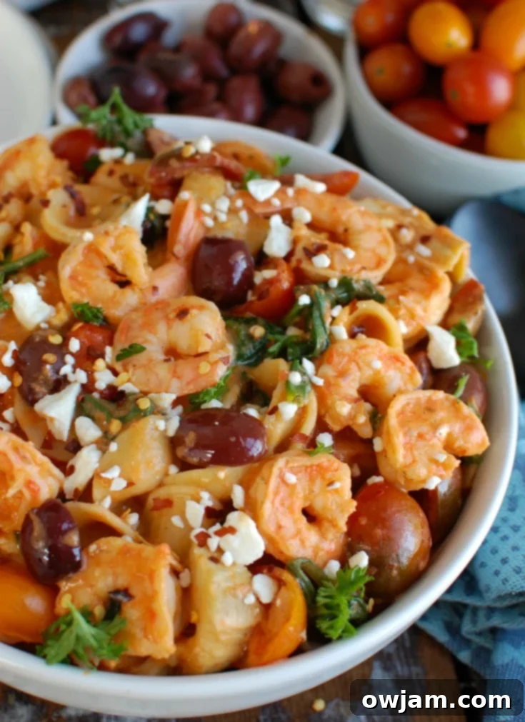 Easy One-Pot Mediterranean Shrimp Pasta 2 One Pot Mediterranean Shrimp Pasta in a large skillet, ready to serve.