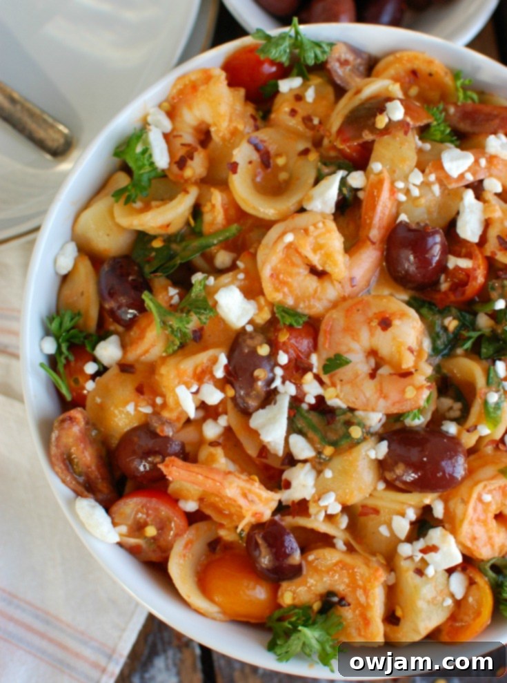 Easy One-Pot Mediterranean Shrimp Pasta 3 Close-up of One Pot Mediterranean Shrimp Pasta garnished with fresh parsley.
