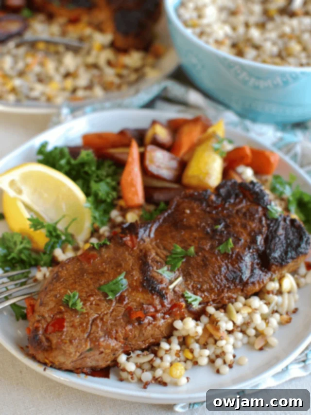 Perfectly pan-seared New York Strip Steak generously coated in a vibrant red harissa marinade, garnished with fresh herbs and ready to be served.