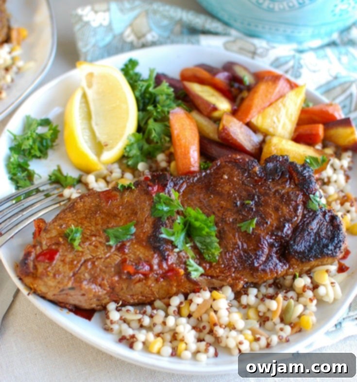 Expertly sliced Pan Seared Harissa New York Strip Steak revealing its perfectly cooked medium-rare interior, garnished with fresh parsley.