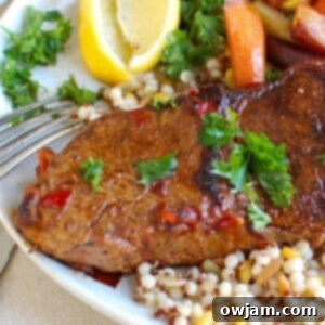 A beautifully plated Pan Seared Harissa New York Strip Steak, sliced and garnished, ready to be enjoyed.