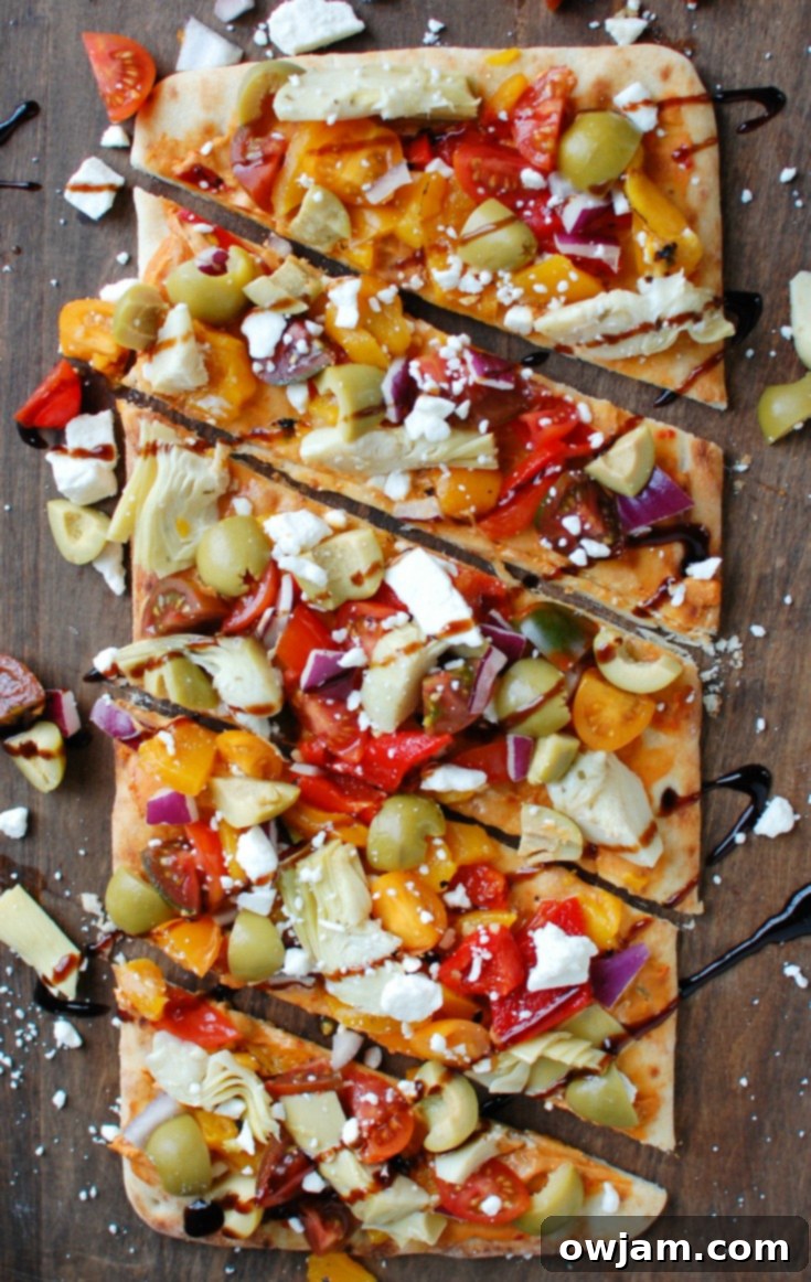 Rustic Mediterranean Flatbread 4 Overhead view of a prepared Mediterranean Flatbread, richly topped and ready to serve as a delicious vegetarian appetizer or meal.