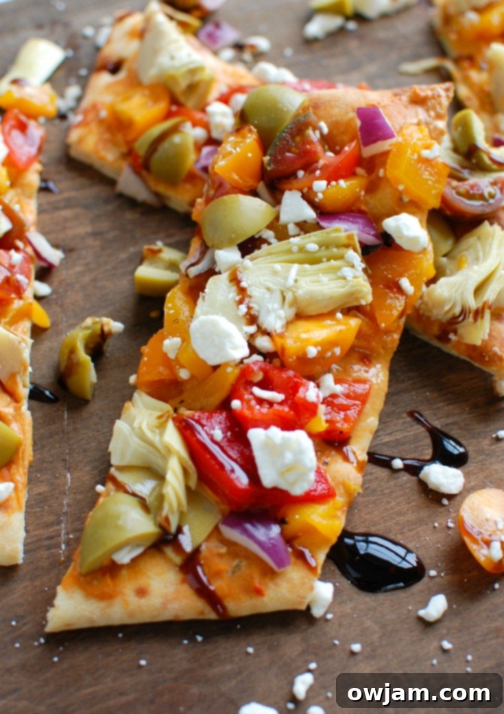 Rustic Mediterranean Flatbread 5 Single slice of Mediterranean Flatbread with detailed toppings, showcasing its readiness as a convenient, flavorful vegetarian option.