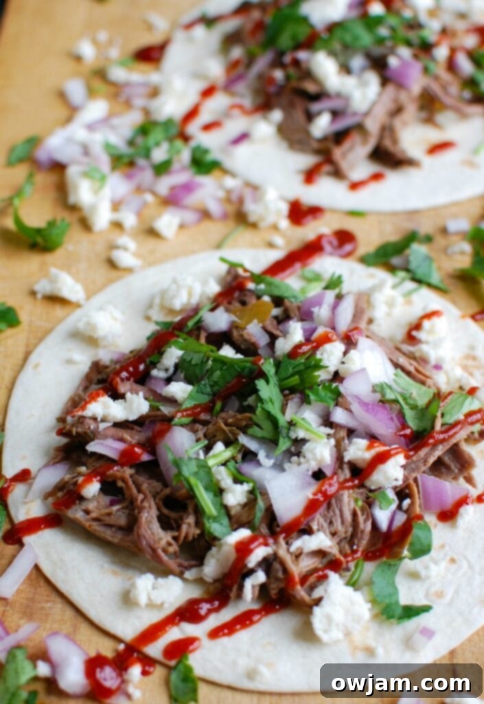 A bowl of Slow Cooker Beef Barbacoa, perfectly shredded and ready to be served.