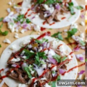 Slow Cooker Beef Barbacoa on a cutting board