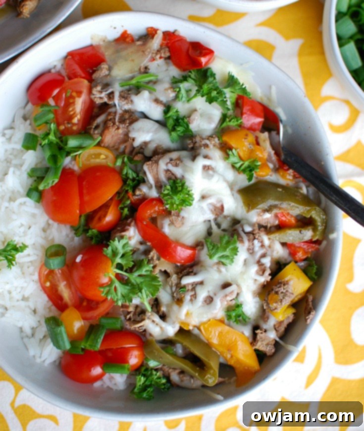 Set-and-Forget Philly Cheesesteak Rice Bowls 4 Beef and bell peppers cooking in a slow cooker for Philly Cheesesteak Rice Bowls