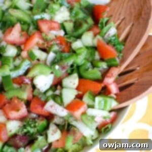 Easy Lebanese Salad in white bowl with wooden spoons