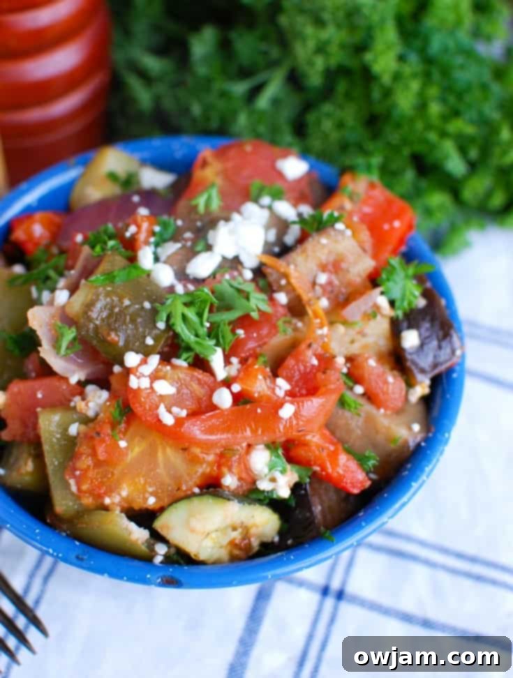 Greek Briami Roasted Vegetables 2 Close-up of vibrant Greek Roasted Vegetables (Briami) fresh from the oven, showcasing a mix of zucchini, eggplant, potatoes, and tomatoes.