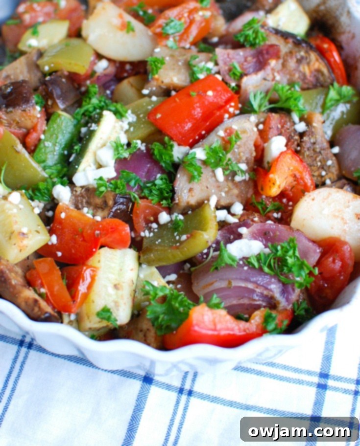 Greek Briami Roasted Vegetables 3 A vibrant close-up of Greek Roasted Vegetables (Briami) with visible chunks of potato, zucchini, and bell pepper, glistening in tomato sauce.