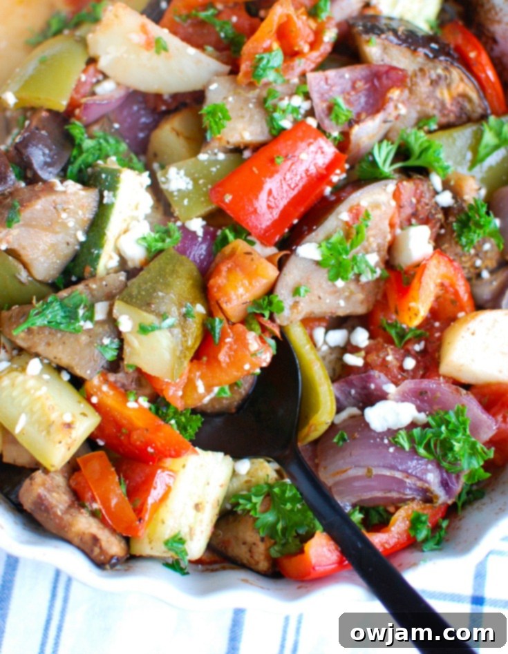 Greek Briami Roasted Vegetables 5 A large baking dish filled with richly roasted Greek Vegetables (Briami) topped with fresh parsley, ready to be served.