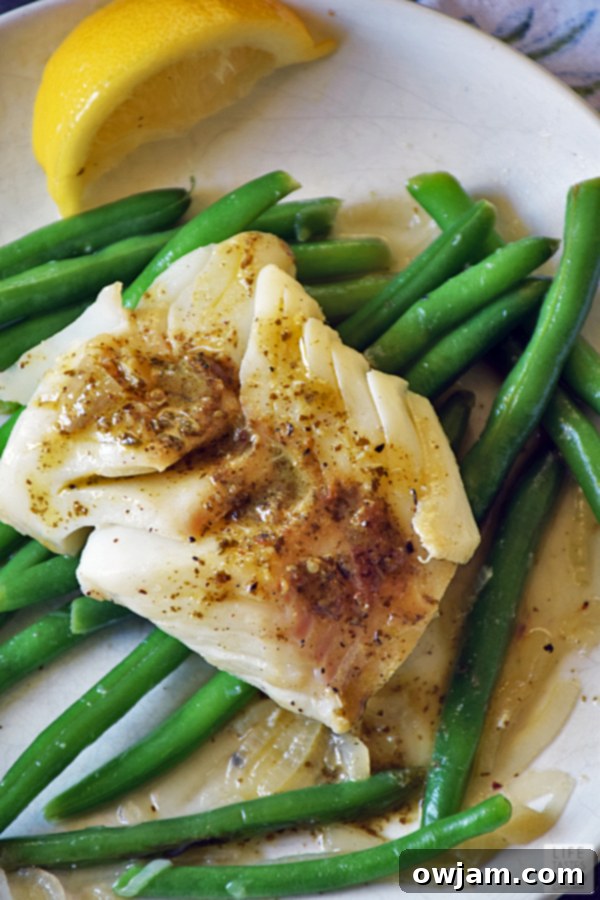 19 Fresh & Healthy Seafood Delights 12 Delicate poached cod fillets served with a vibrant pesto wine sauce, creating a light, healthy, and elegant meal bursting with Mediterranean flavors.