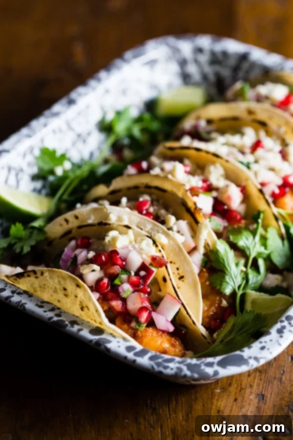 19 Fresh & Healthy Seafood Delights 5 Delicious shrimp tacos topped with a fresh and vibrant apple pomegranate salsa, offering a sweet, tart, and savory flavor combination perfect for a healthy and exciting meal.