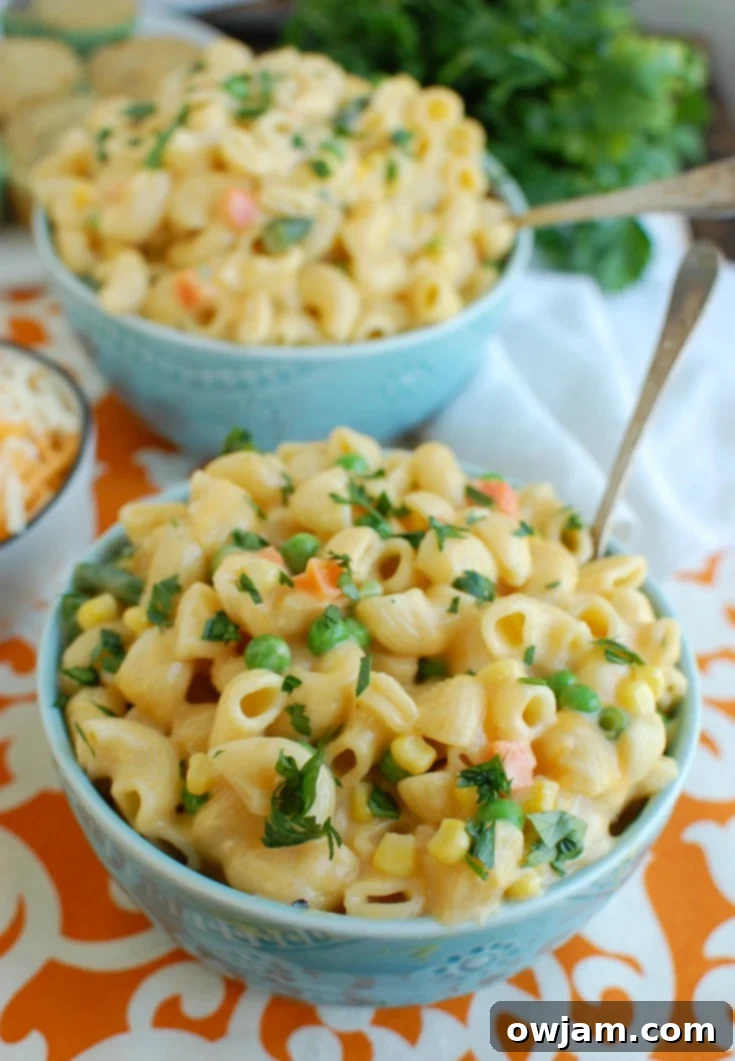 One Pot Veggie Mac Magic 2 Instant Pot Vegetable Mac and Cheese in blue bowl with spoon