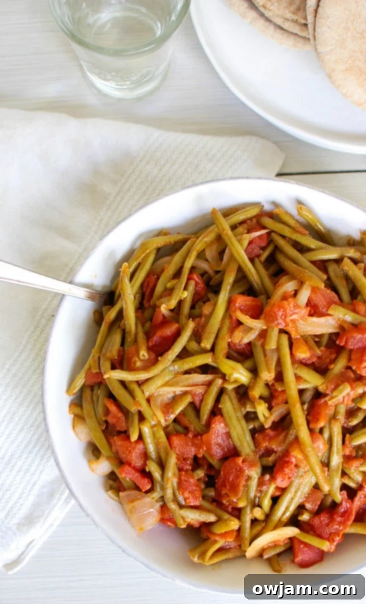 Easy Instant Pot Lebanese Green Beans 5 A serving of Lebanese Green Beans in a white bowl, ready to be enjoyed.