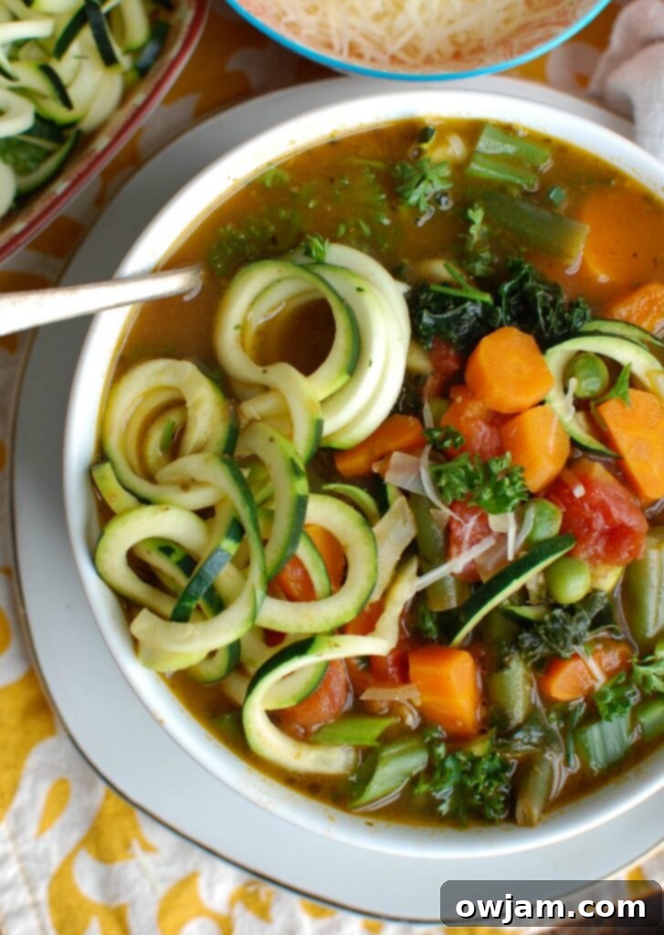Vibrant Spring Minestrone 3 An overhead view of a generously portioned bowl of Spring Vegetable Minestrone, highlighting the colorful medley of vegetables and zucchini noodles, ready to be enjoyed.