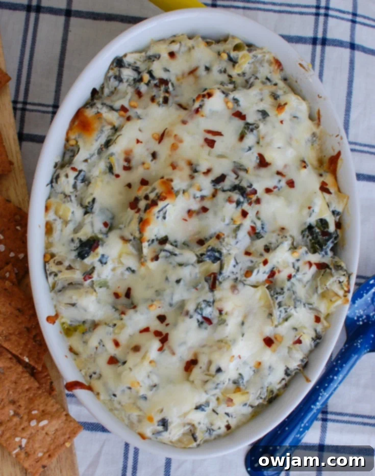 Zesty Lemon Spinach Artichoke Dip 3 Lemon Spinach Artichoke Dip in white dish ready to serve