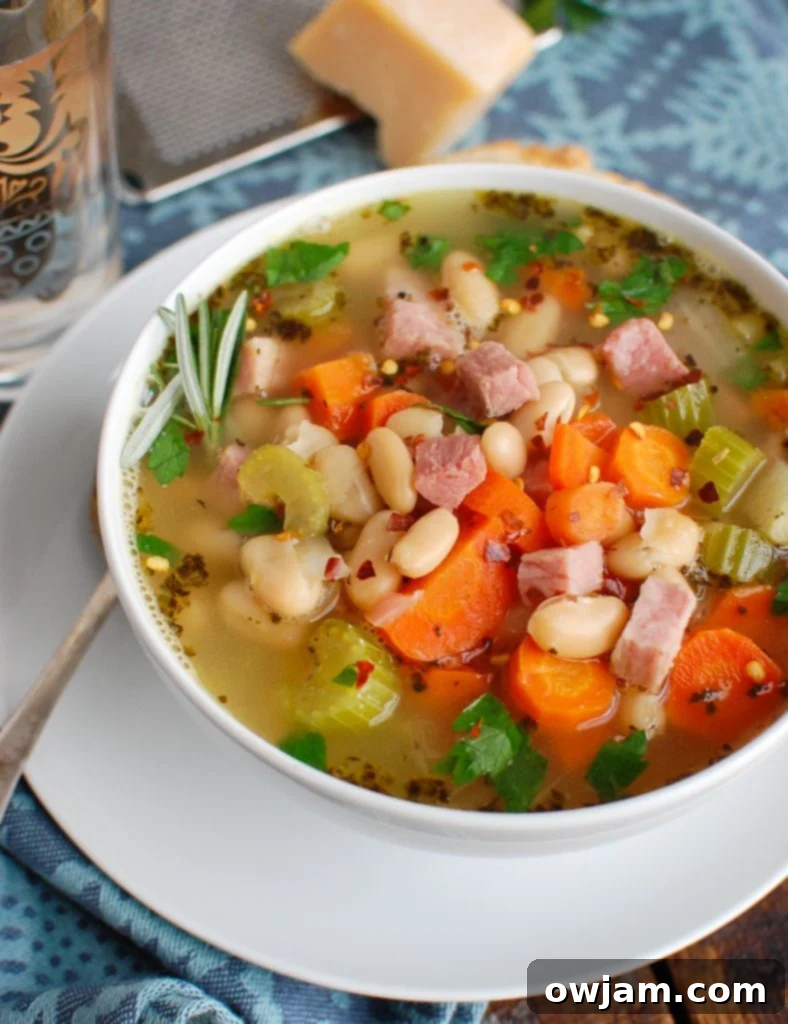 Hearty White Bean and Ham Soup 4 White Bean and Ham Soup served with a side of crusty bread, perfect for dipping.