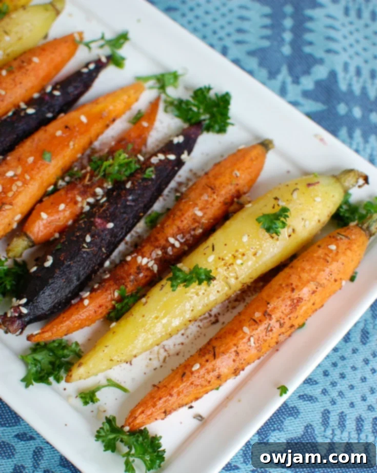 A serving of Za'atar Roasted Carrots on a white plate, garnished with fresh parsley.
