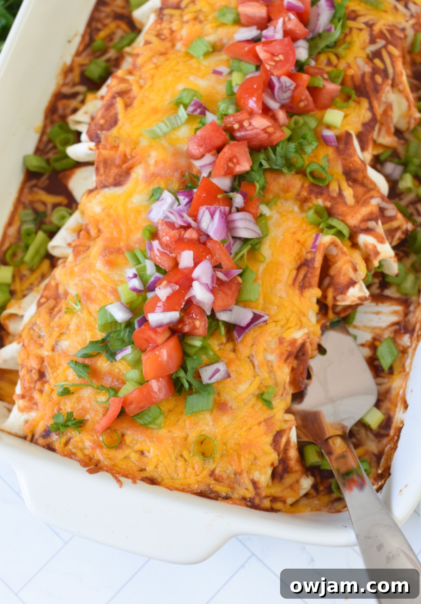 Classic Beef Enchiladas 33 Three-Cheese Beef Enchiladas in a baking pan, golden brown and bubbly from the oven.