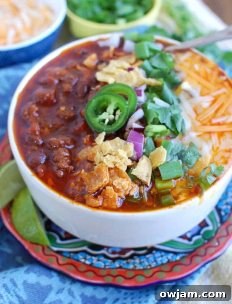Quick Instant Pot Beef Chili 2 Easy Instant Pot Beef Chili Side View, garnished with fresh cilantro and cheese.