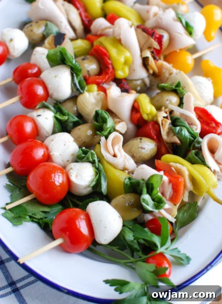 Colorful Mediterranean Antipasto Skewers arranged on a white plate, perfect for party appetizers.
