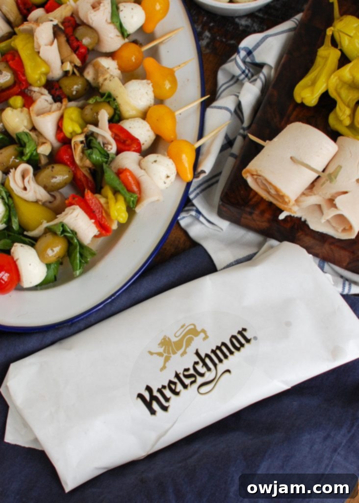 Sliced Kretschmar Off The Bone turkey deli meat, ready to be added to Mediterranean Antipasto Skewers, showcasing its quality texture.