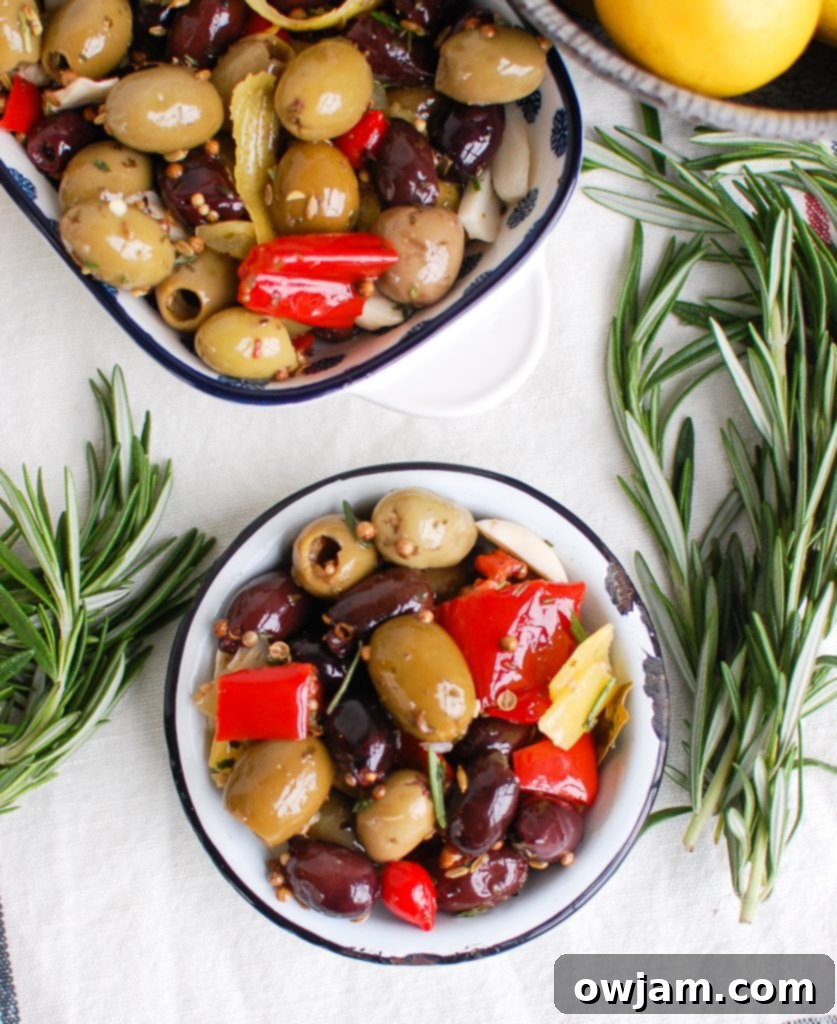 Lemon Marinated Olives served in a small rustic bowl with a wooden spoon
