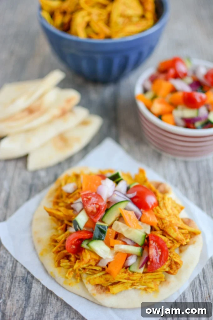 9 Mouthwatering Mediterranean Slow Cooker Creations 4 Succulent Persian Pulled Chicken, slow-cooked to perfection with aromatic spices like saffron and turmeric, ready for serving.