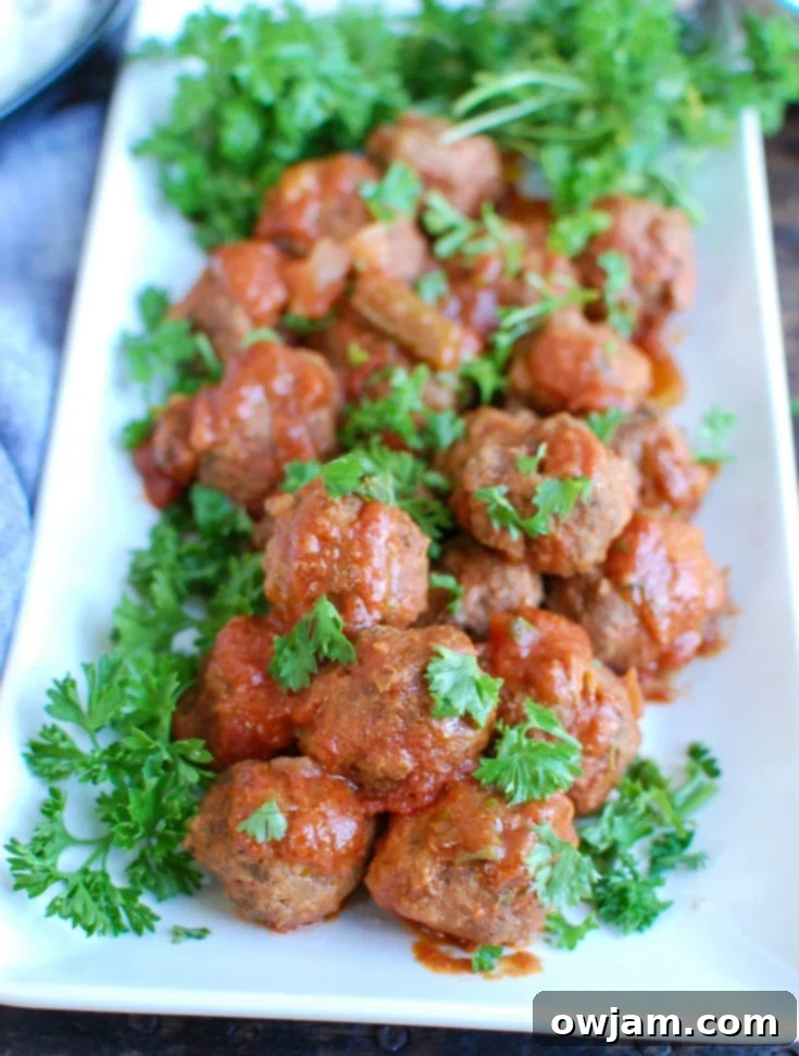 9 Mouthwatering Mediterranean Slow Cooker Creations 8 A dish of flavorful Slow Cooker Mediterranean Beef Meatballs served with traditional Lebanese Green Beans, garnished with fresh parsley.