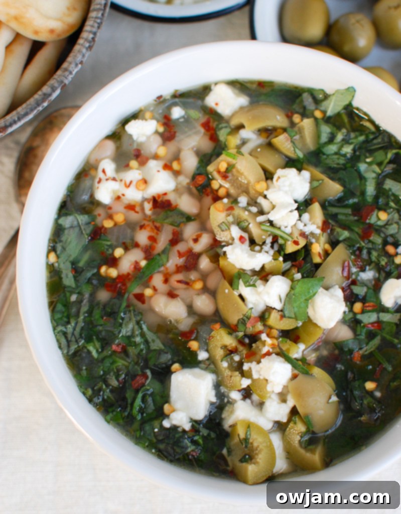 Mediterranean White Bean Soup in a white bowl with bread