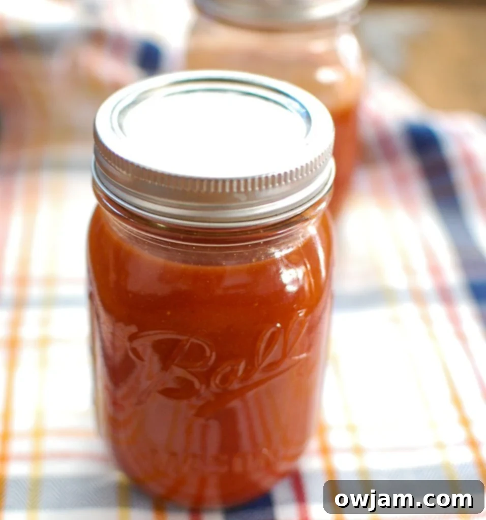 Two jars of homemade barbecue sauce, ready for storage or gifting