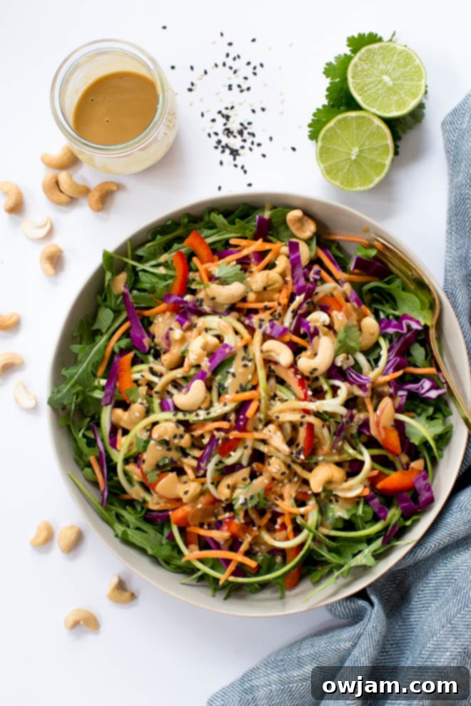 Zucchini Noodle Pad Thai - A vibrant bowl of Zucchini Noodle Pad Thai, featuring spiralized zucchini, fresh vegetables, and a savory sauce, garnished with peanuts and lime.