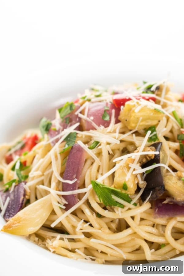 Garlic Roasted Vegetable Pasta - A rustic pasta dish with abundant garlic-roasted vegetables and fresh herbs, served in a bowl.