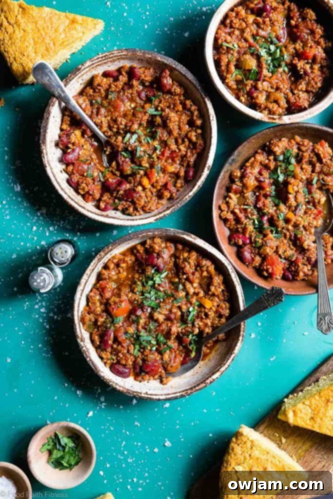 Instant Pot Vegan Chili - A rich, comforting bowl of vegan chili, garnished with fresh cilantro and a dollop of vegan sour cream, perfect for a hearty meal.