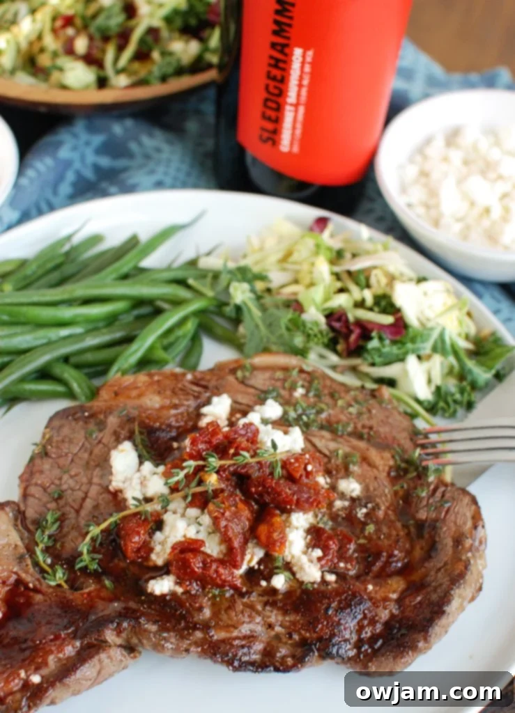 Pan-Seared Ribeye Steaks with Creamy Goat Cheese and Sweet Sun-Dried Tomatoes 3 Pan-Seared Ribeye with Goat Cheese and Sun-dried Tomatoes on a White Plate