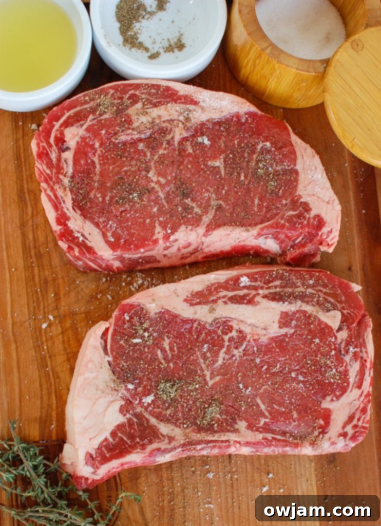Pan-Seared Ribeye Steaks with Creamy Goat Cheese and Sweet Sun-Dried Tomatoes 4 Pan-Seared Ribeye with Goat Cheese and Sun-dried Tomatoes on cutting board