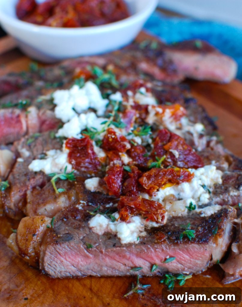 Pan-Seared Ribeye Steaks with Creamy Goat Cheese and Sweet Sun-Dried Tomatoes 5 Pan-Seared Ribeye with Goat Cheese and Sun-dried Tomatoes Cut on Board