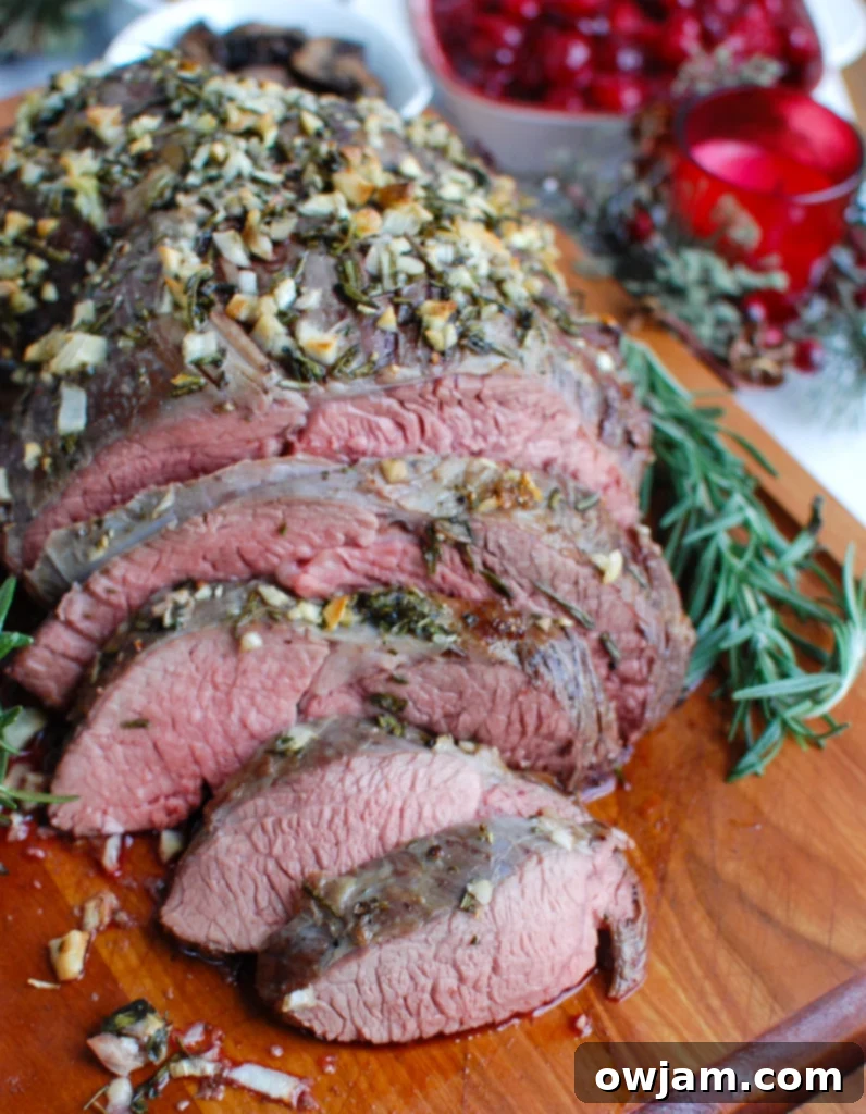 Melt in Your Mouth Roast Beef 5 The Ultimate Herb-Crusted Roast Beef, perfectly carved on a cutting board.