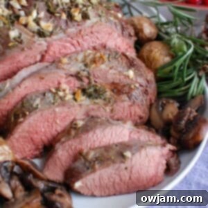 Melt in Your Mouth Roast Beef 6 The Ultimate Herb-Crusted Roast Beef on a white platter