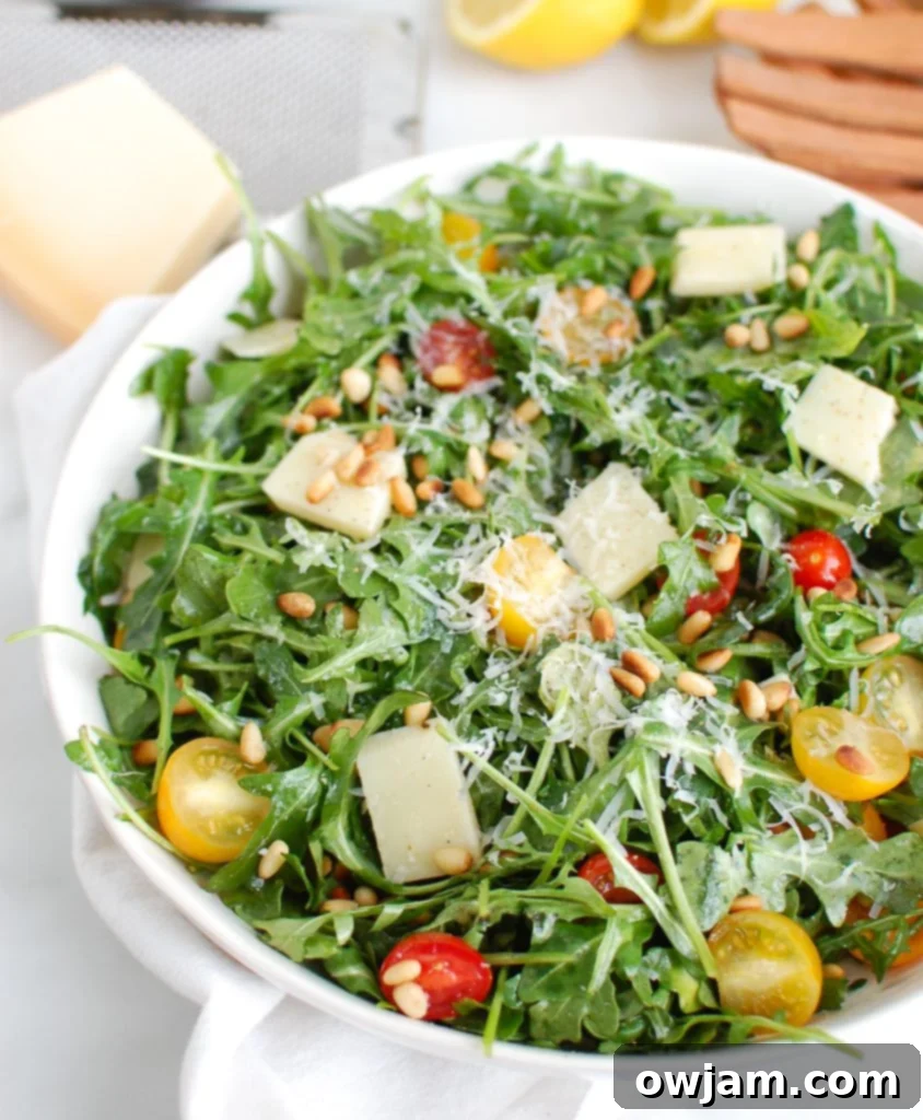 Bright Lemon Arugula Parmesan Salad 5 Lemon Arugula Salad with Pine Nuts with Wood Tongs