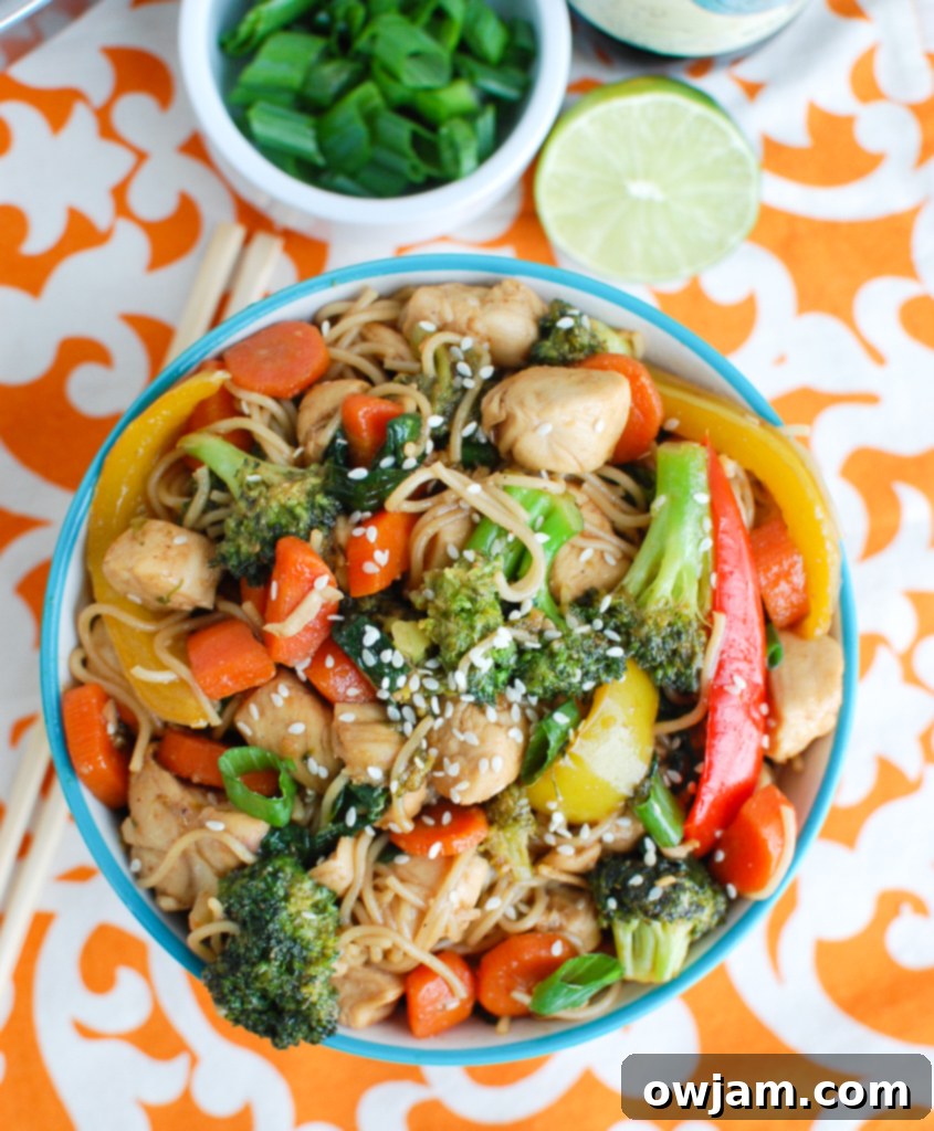 Easy Chicken Ramen Noodle Stir Fry served in a blue bowl with chopsticks