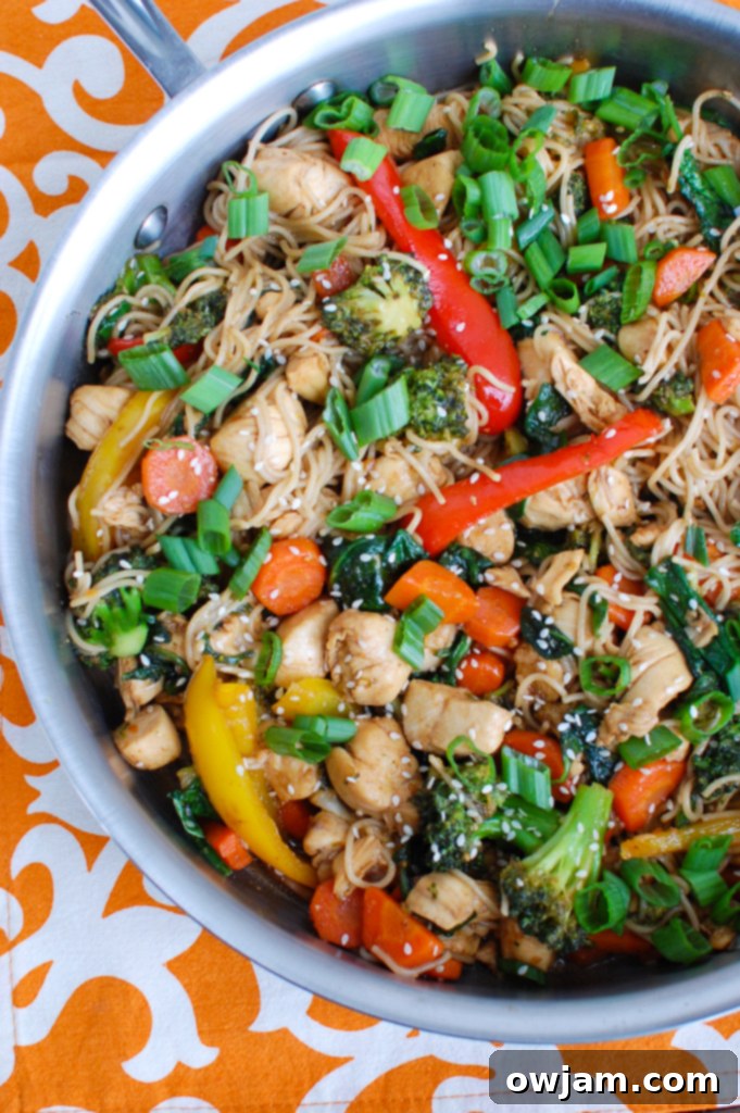 Easy Chicken Ramen Noodle Stir Fry being cooked in a large skillet