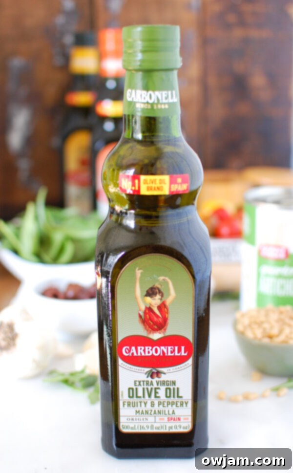 Sun-Kissed Mediterranean Pasta 3 Bottles of Carbonell Manzanilla Extra Virgin Olive Oil, highlighting the quality olive oil used in the recipe.